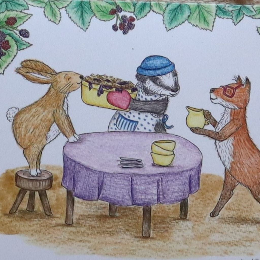 Blackberry Crumble greetings card by Kerry Dilks. Features a lovely brambly border and a Wind In the Willows-esque scene of badger in a pinny holding the crumble aloft, while rabbit sneaks a sniff and fox brandishes a jug of custard. Available from Bramble and Fox UK hygge shop."