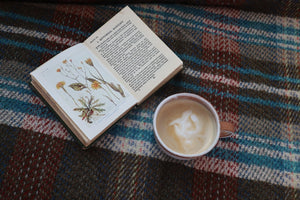 alt="recyled wool tartan blanket with book and rustic mug. Available at Bramble and Fox UK hygge homeware shop"