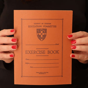 alt="close up shot of Bex Massey's hands holding a vintage County of Durham school exercise book. Perfect for stationery lovers. Available from Bramble and Fox UK hygge shop."