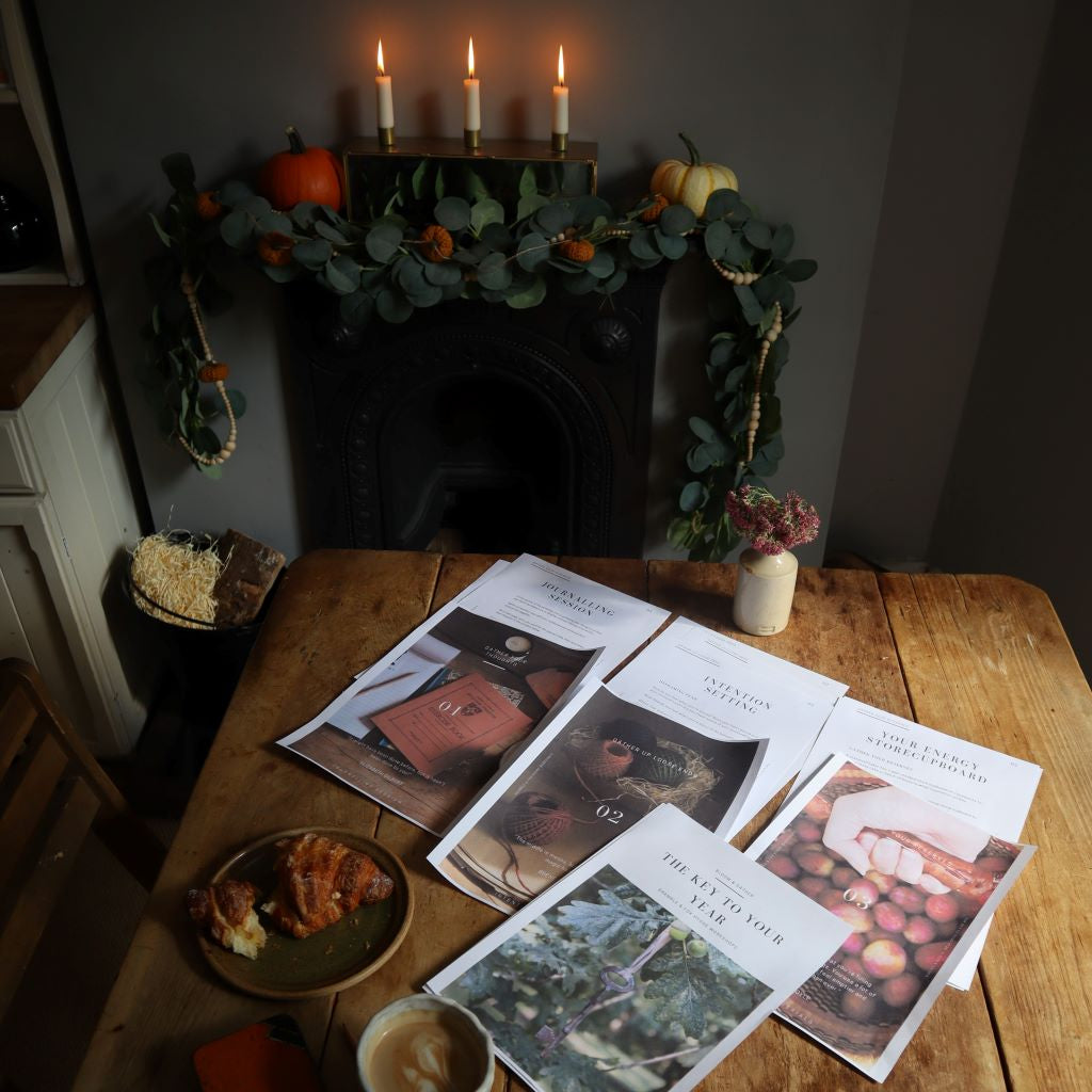 alt="flatlay of workshop materials from The Key to Your Year: Bloom and Gather, led by hygge mentor, Bex Massey. Fireplace decorated for autumn with pumpkin garland and autumn decor. Available from Bramble and Fox UK hygge shop"