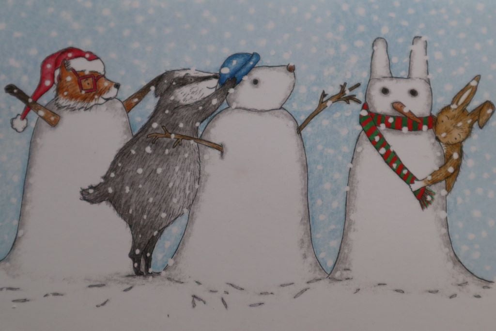 alt="close up of Snow Animals christmas card by Kerry Dilks. Features fox, badger and rabbit as they lark about in the snow. Available from Bramble and Fox UK hygge gifts and homewares."