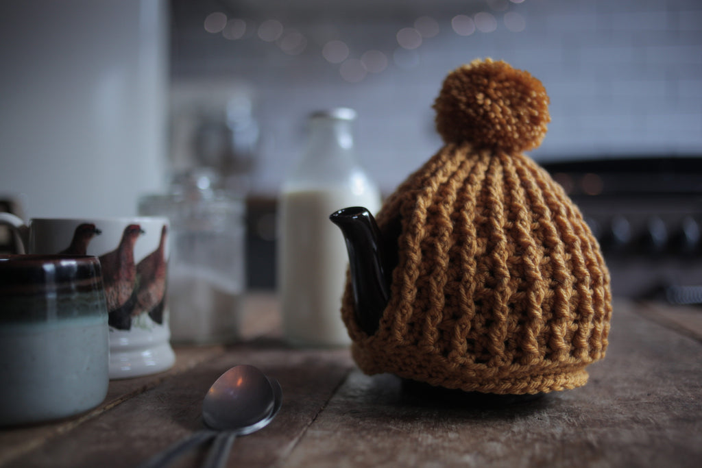 mustard hand crochet chunky knit tea cosy with pom pom made by Rosie and Max Crafts
