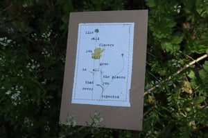 alt="handmade postive affirmation card by abby monroe resting on a bed of wildflowers. card available from bramble and fox uk hygge shop"