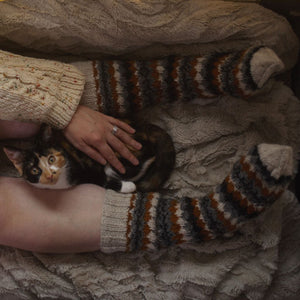 alt="woman's legs wearing fair isle knitted socks. A calico cat is also in the picture. Socks available from Bramble and Fox UK hygge homeware and gifts"