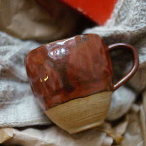 alt="tactile hand built pinch pot mug with Autumnal brown glaze by Clay Studio. Available from Bramble and Fox UK hygge homeware shop"
