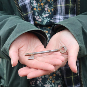 alt="vintage key held in palm of hand. Available from Bramble and Fox UK hygge shop."