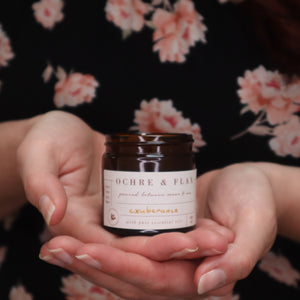 alt="hands holding Ochre and Flax Exuberance candle. Available from Bramble and Fox UK hygge homewares"