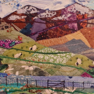 alt="close up of Snowdon patchwork textile art by Josie Russell, available from Bramble and Fox UK hygge homeware shop"